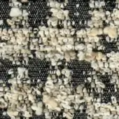 Dark charcoal gray woven fabric texture with speckled pattern of cream, beige, and tan granules creating a mottled, organic surface.